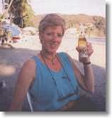 Susan, the love of my life, enjoys a late-afternoon beer on the beach.