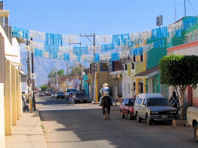 Cowboy rides down a Tequila street